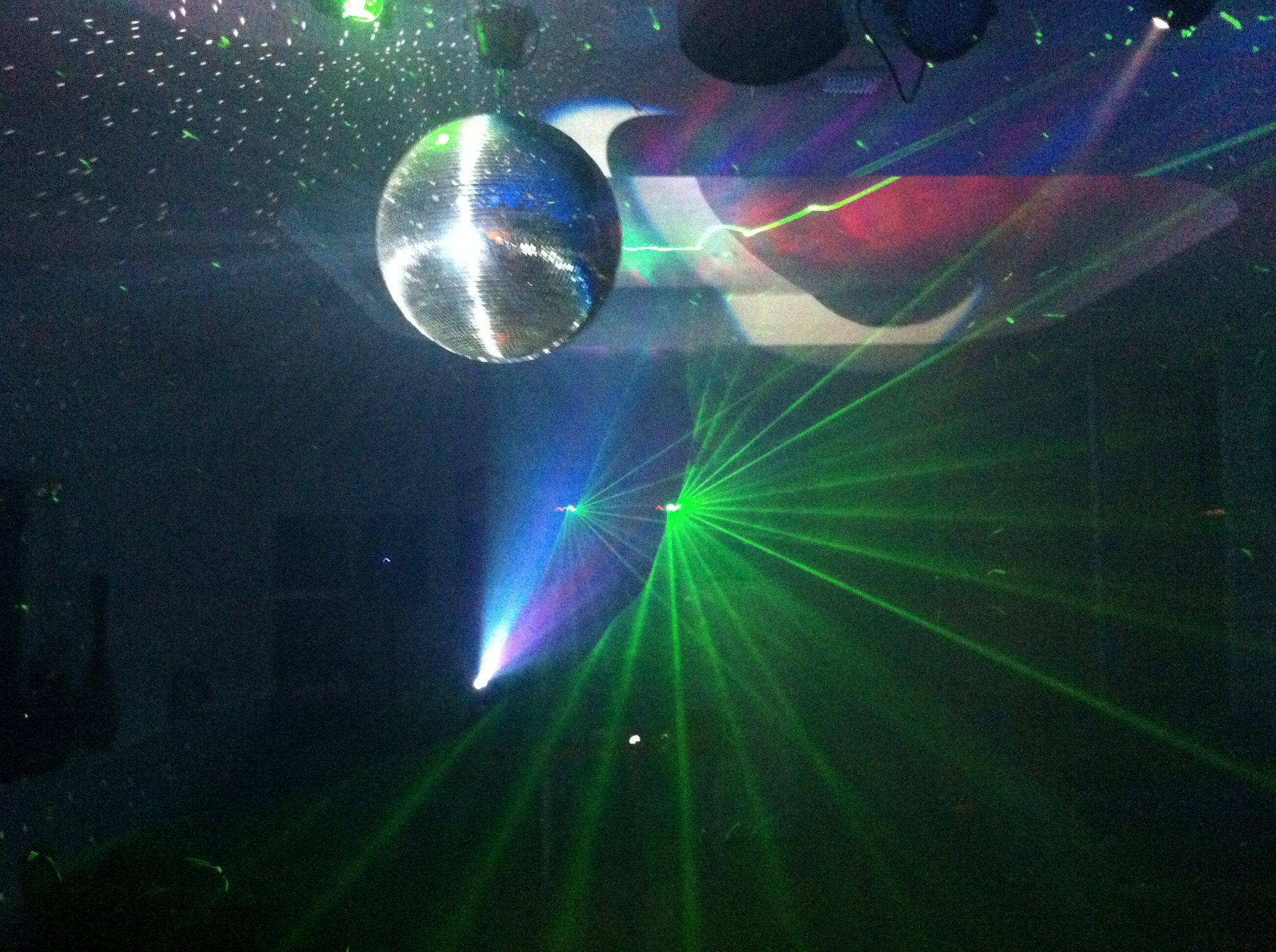 Disco ball and green lasers filling the room
